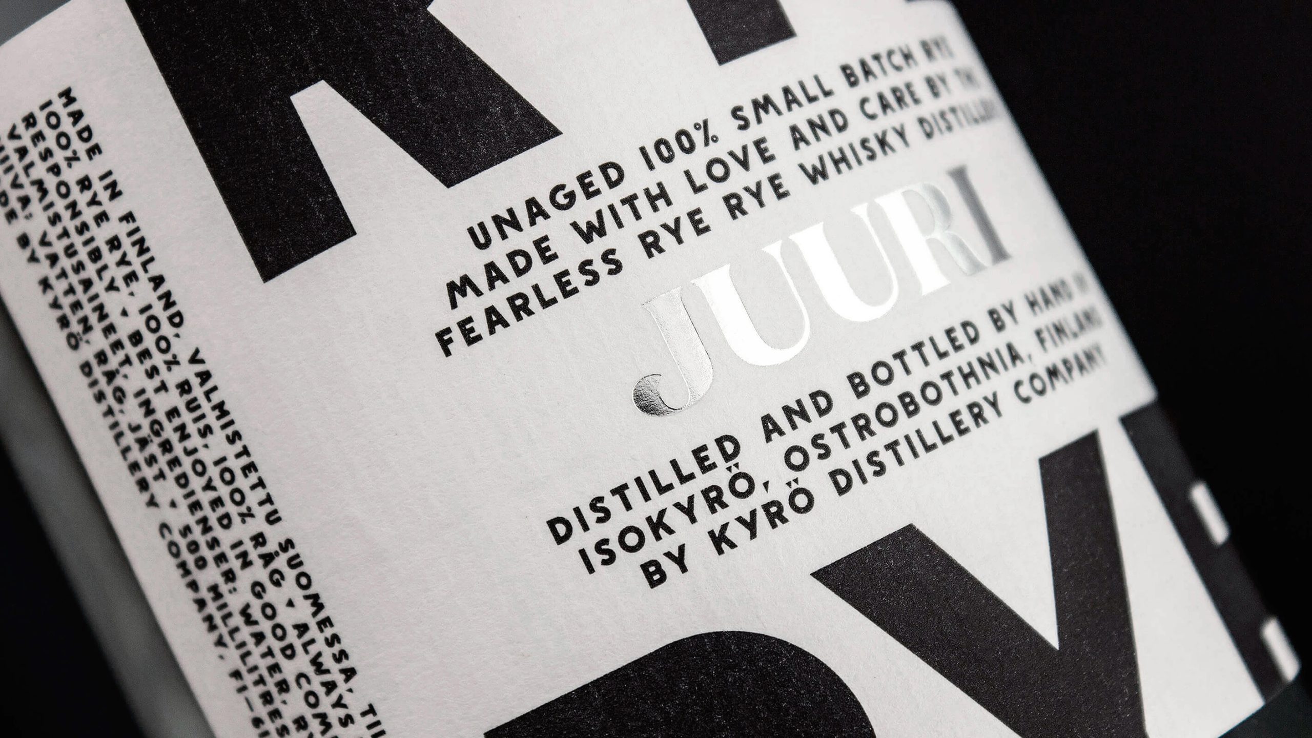 Kyrö Distillery Juuri rye whisky bottle label in bold black and white typography with silver foil stamping.
