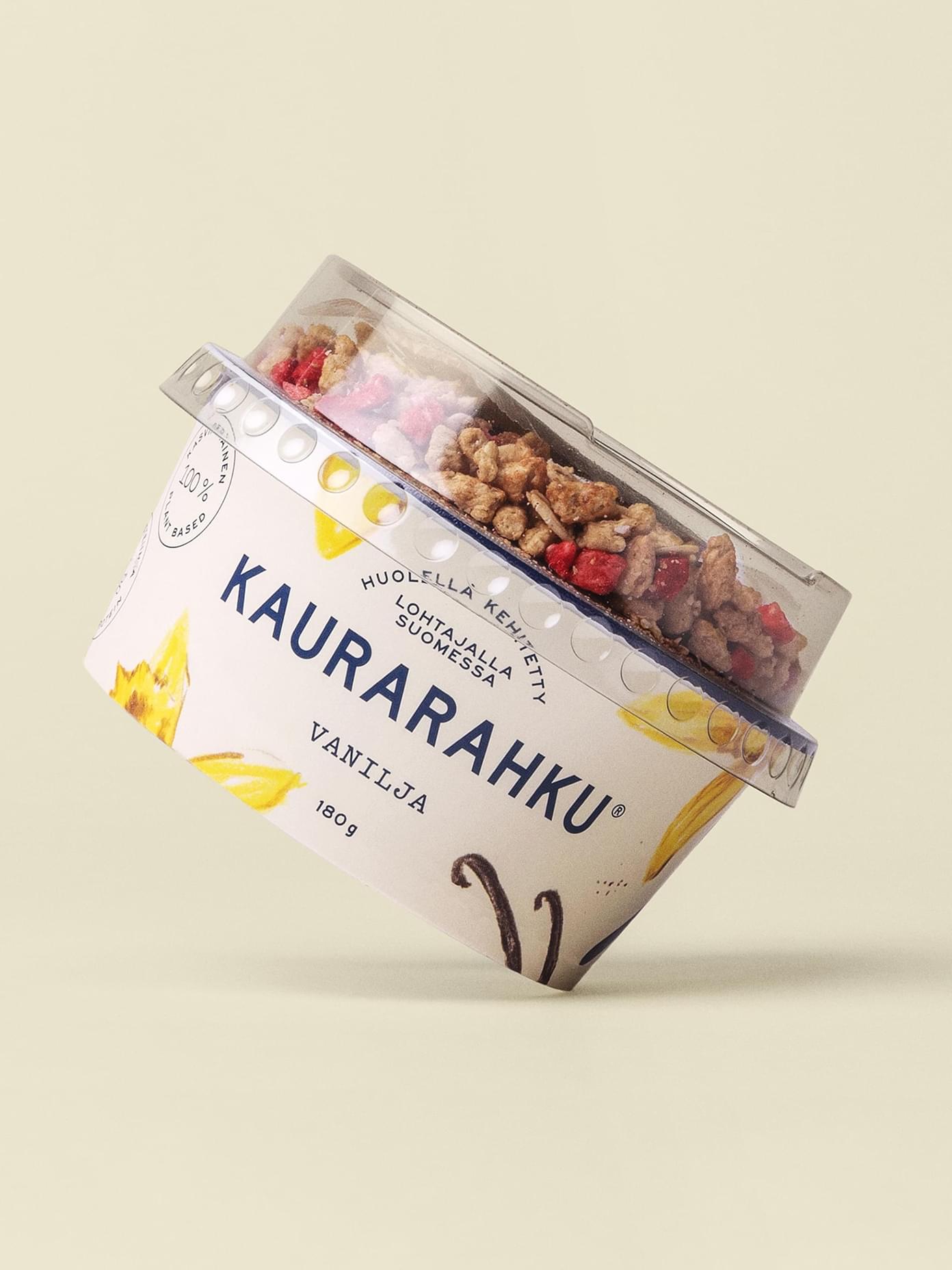 Kaurarahku Vanilja 180g oat quark cup tilted to show granola topping compartment, with vanilla-illustrated label.