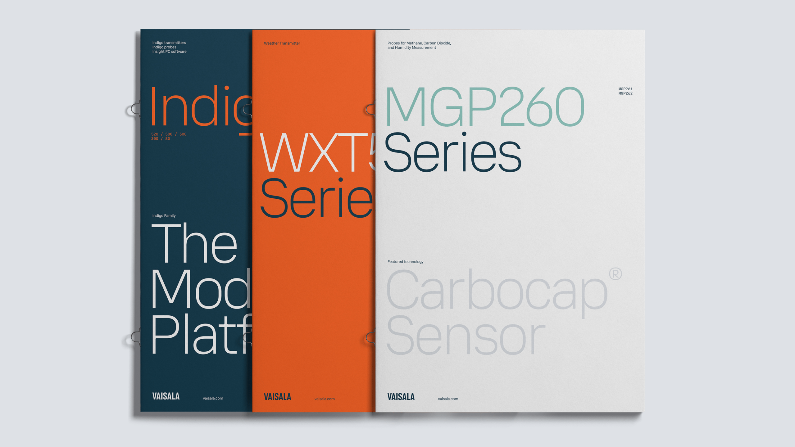 Three overlapping Vaisala product brochure covers in dark teal, orange, and off-white.