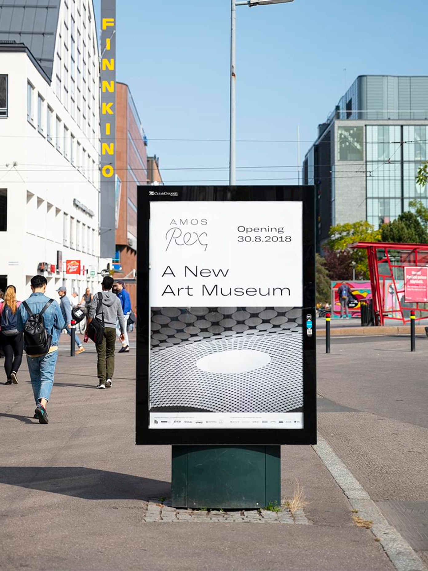 Bus stop advertisement announcing Amos Rex's opening as 'A New Art Museum,' featuring a photo of the dome skylights.