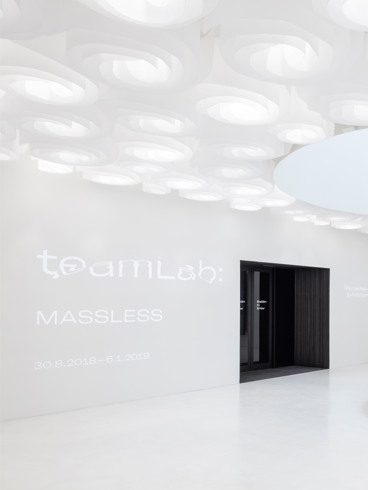 Wide view of Amos Rex's ceiling installation and gallery entrance for the 'teamLab: MASSLESS' exhibition.