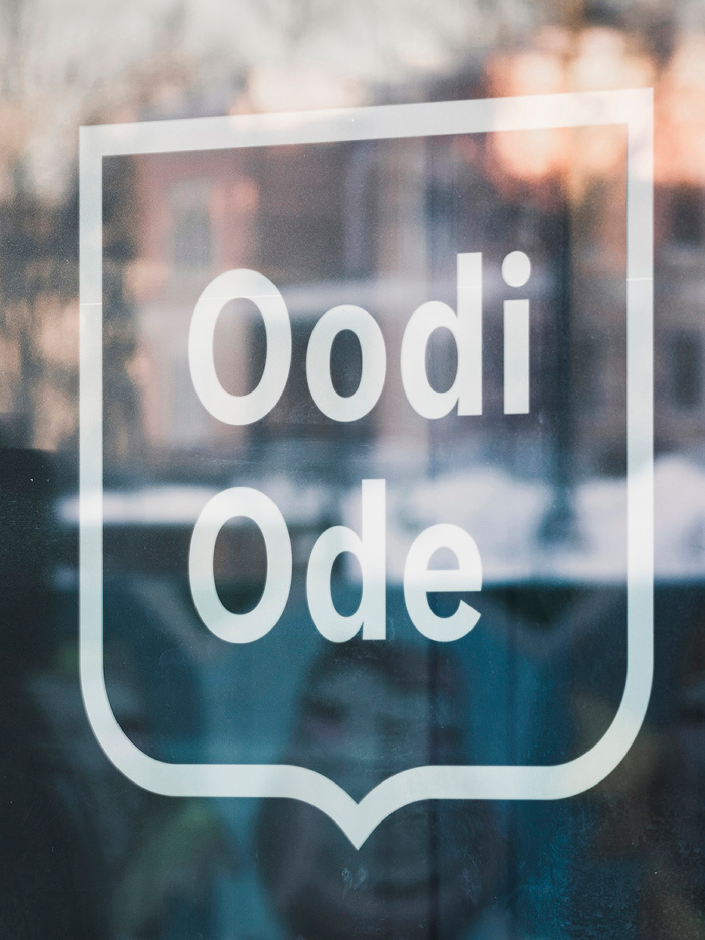 The wordmark etched onto a glass panel at Helsinki's central library.