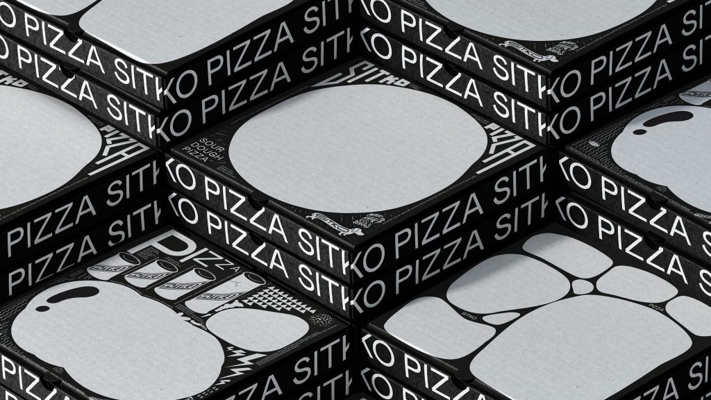 Sitko Pizza black boxes with bold white repeating typography on sides.