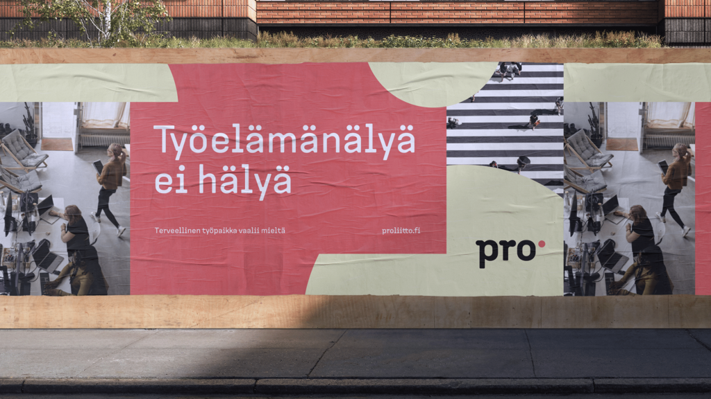 Pro liitto billboard with Finnish text 'Työelämänälyä ei hälyä' on red shape, muted green accents, and office scene photos.