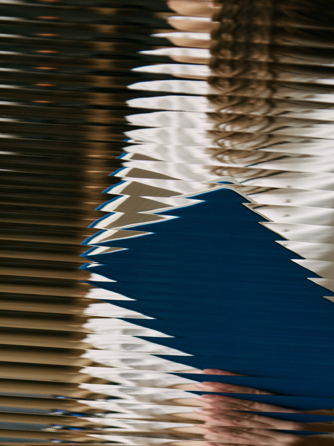 Rippling water reflecting blue and white geometric shapes, part of Avance brand identity by Werklig.