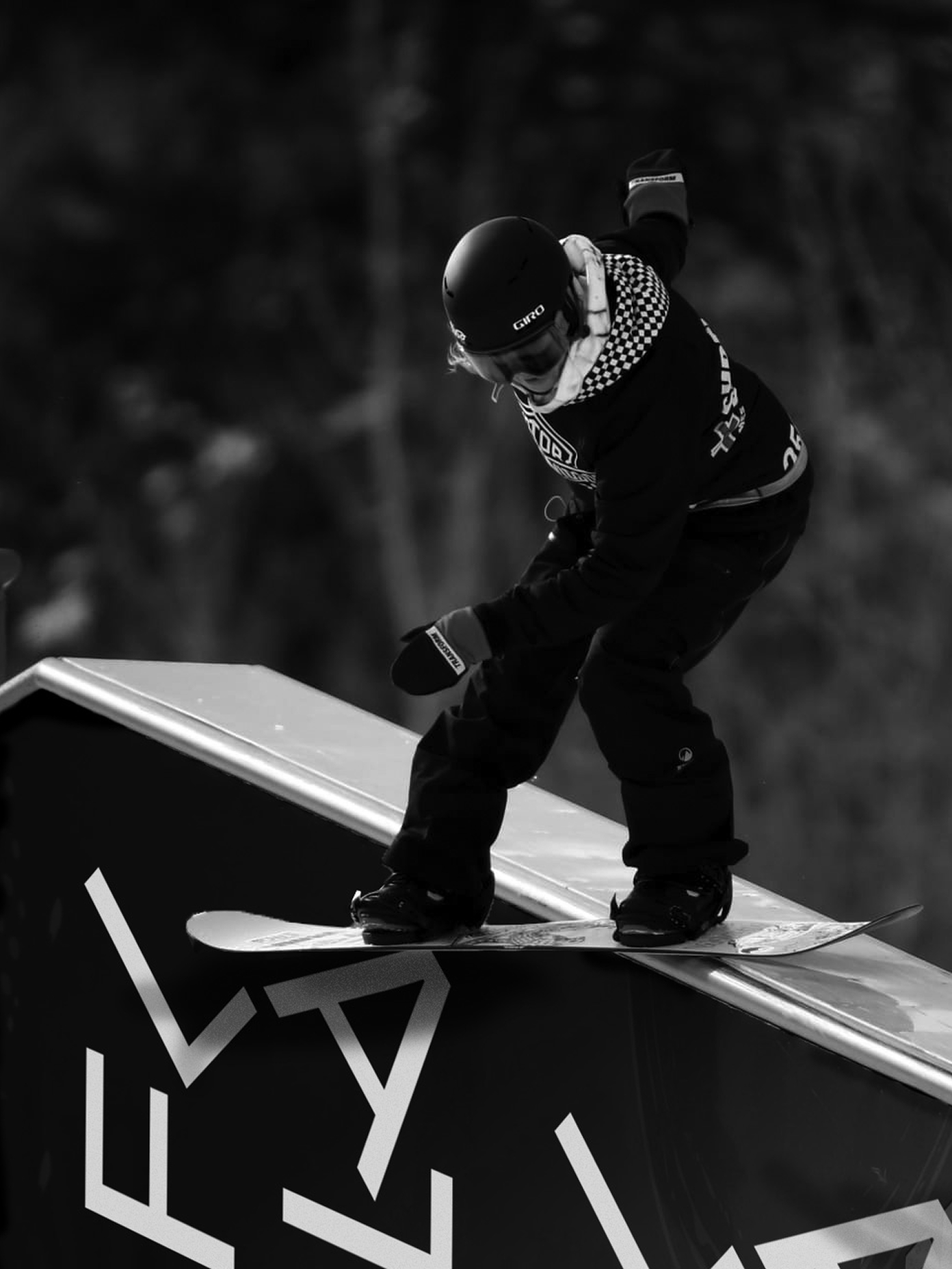 Snowboarder grinding a metal rail at a FLAT event.