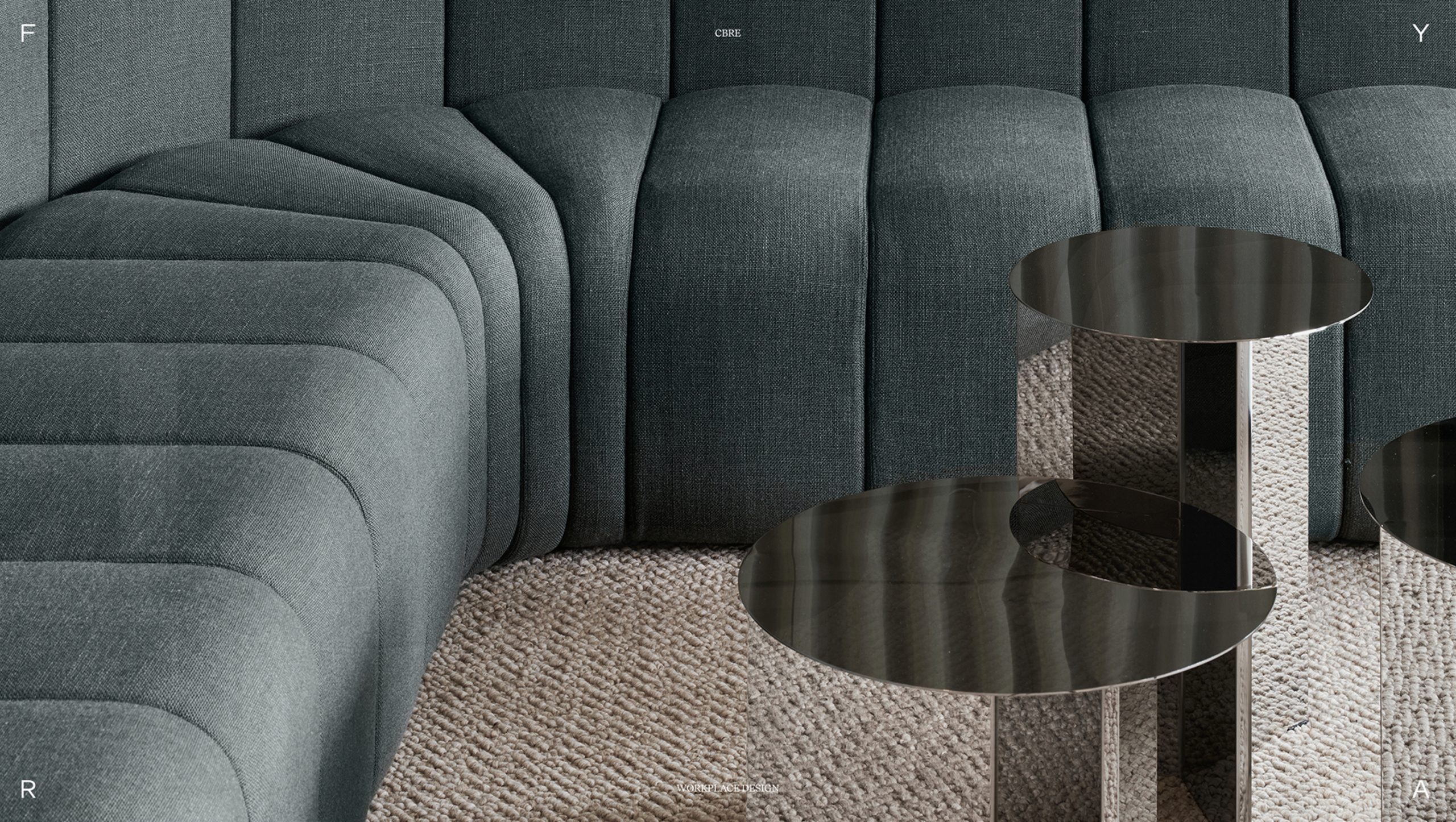CBRE workplace lounge with teal modular sofa, stacked ottomans, and smoked mirror side tables on a textured beige rug.