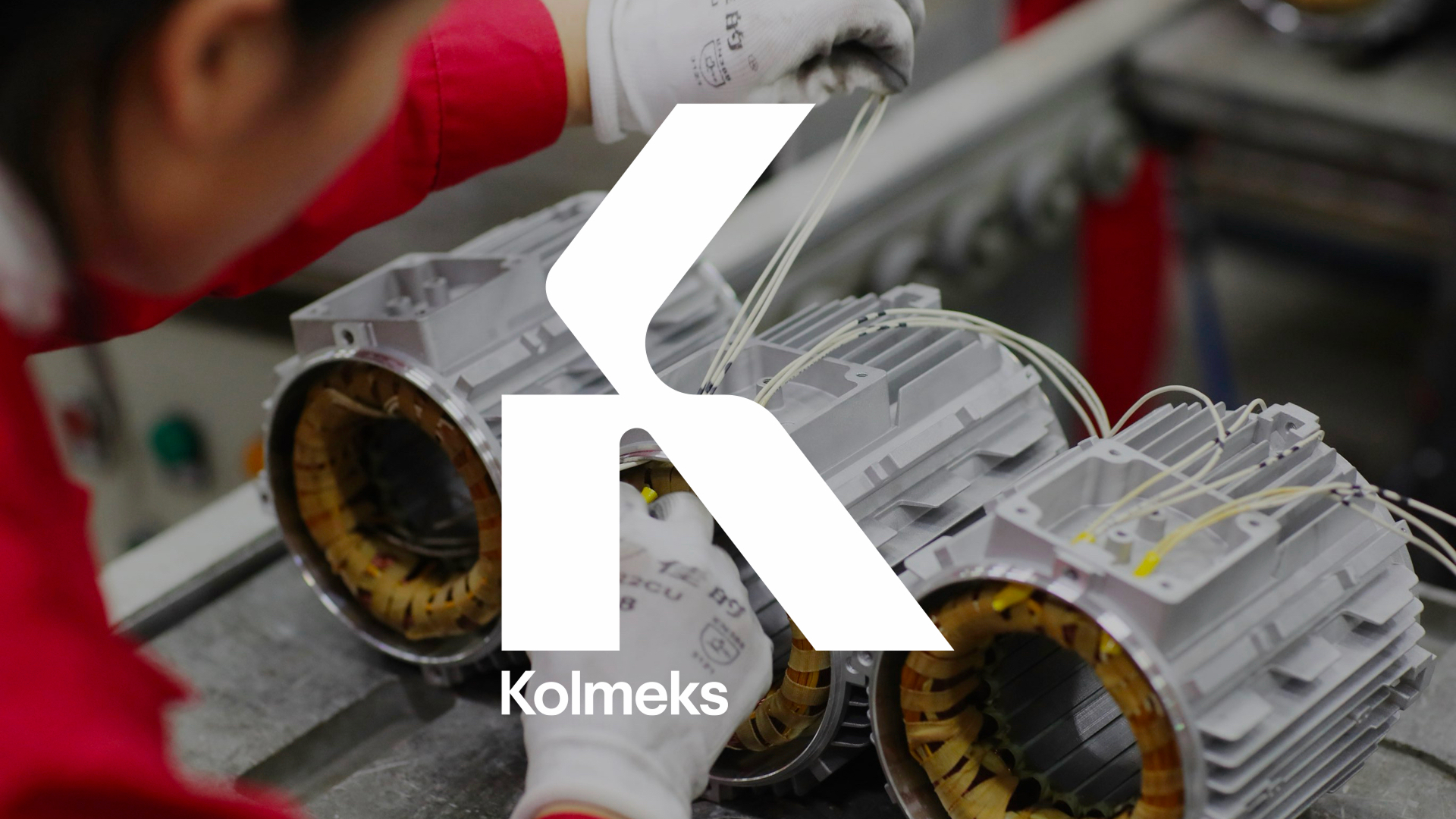 Kolmeks branded visual showing a worker assembling electric motors on a factory floor, with the white Kolmeks logo overlaid.
