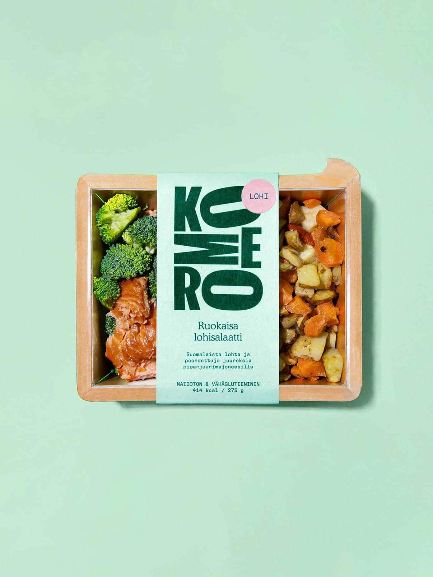 Komero branded meal box with salmon, broccoli, and roasted root vegetables, featuring mint green paper sleeve packaging.