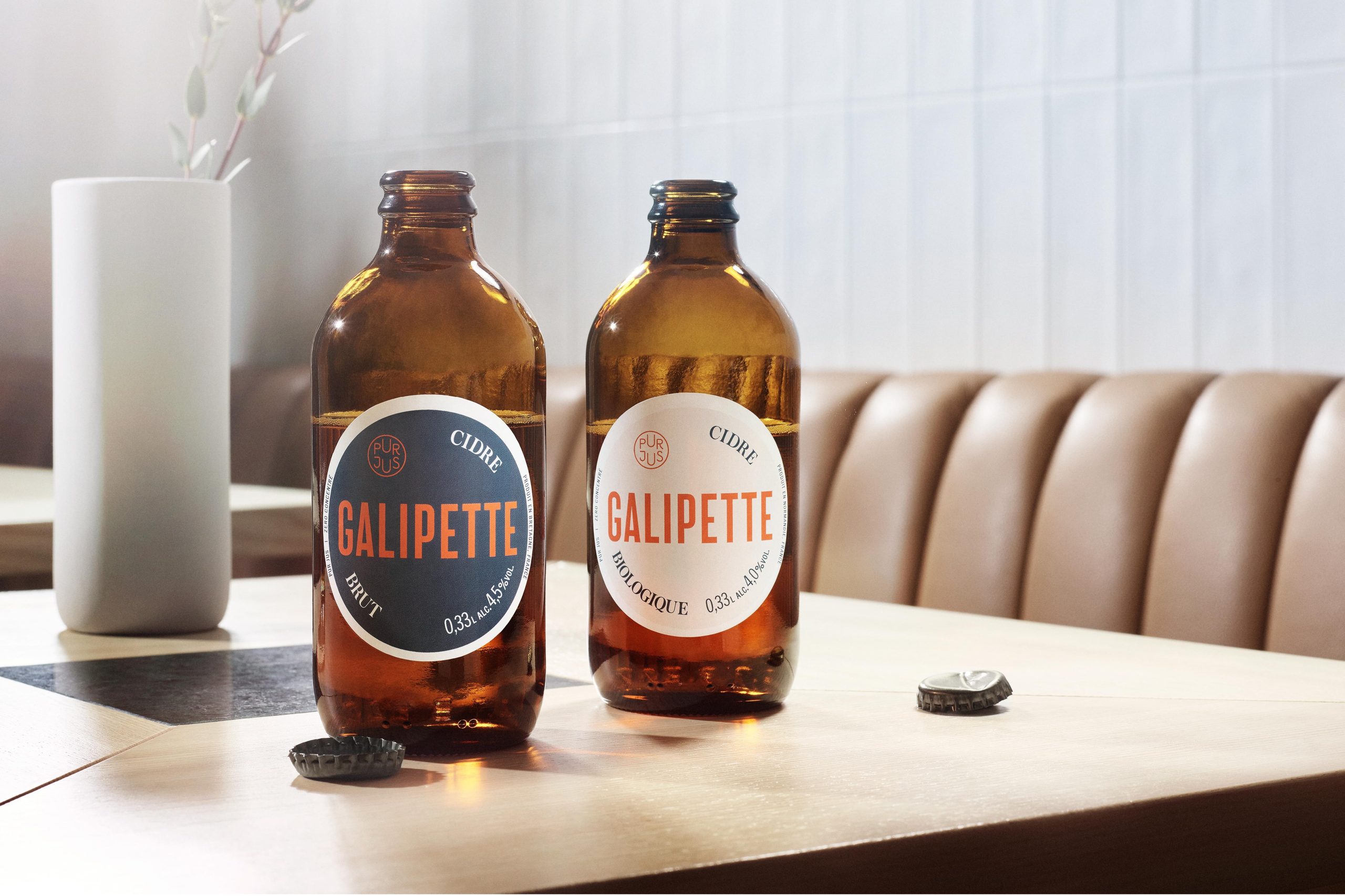 Two Galipette cider bottles on a café table